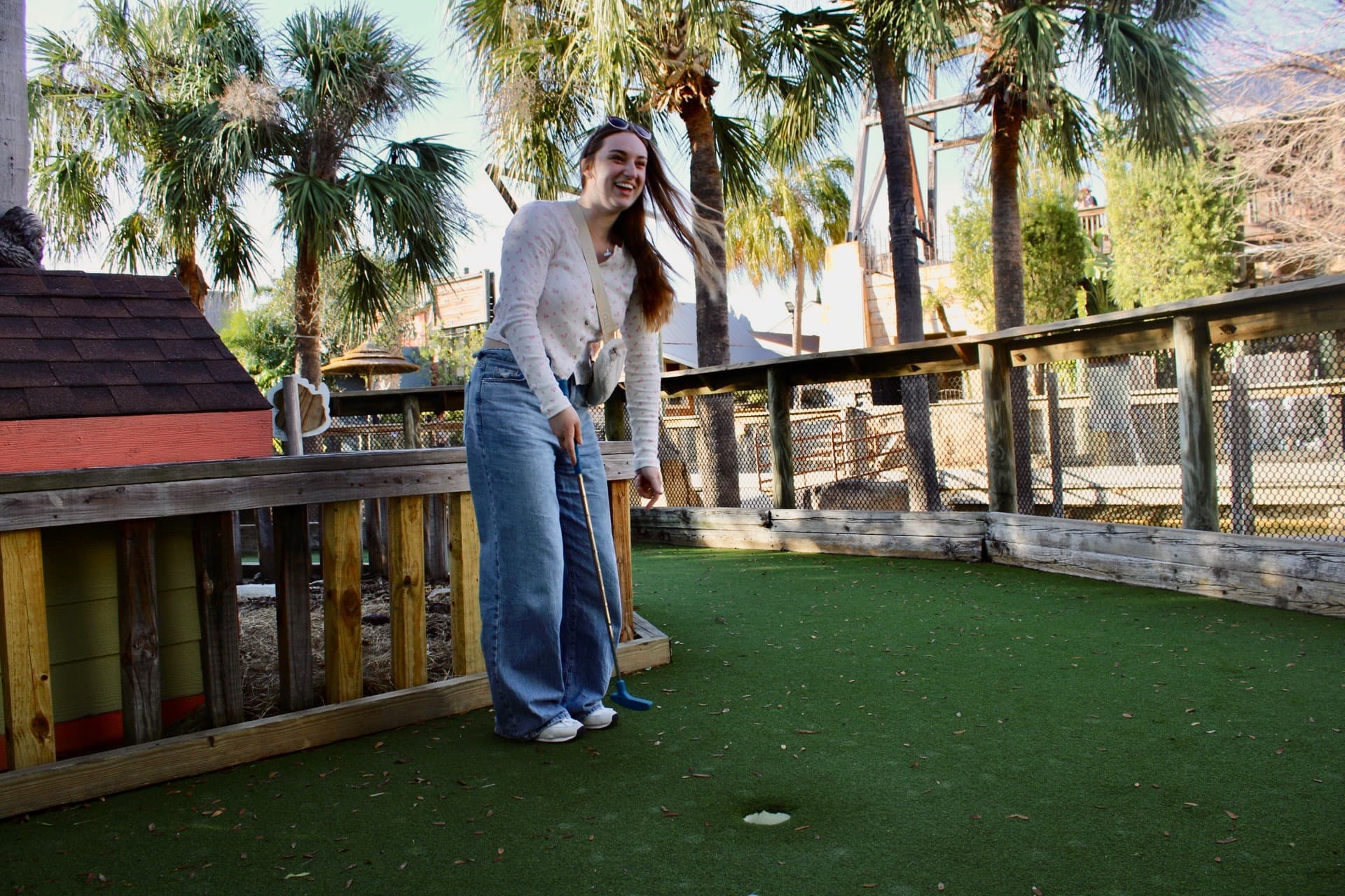 Visitors playing miniature golf